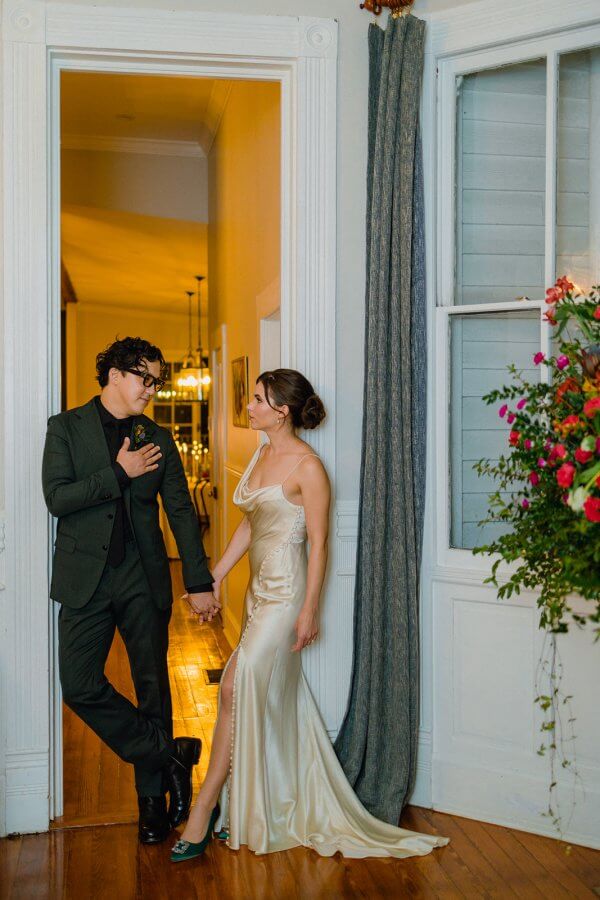 Emily and Dennis pose outside on porch wedding photo