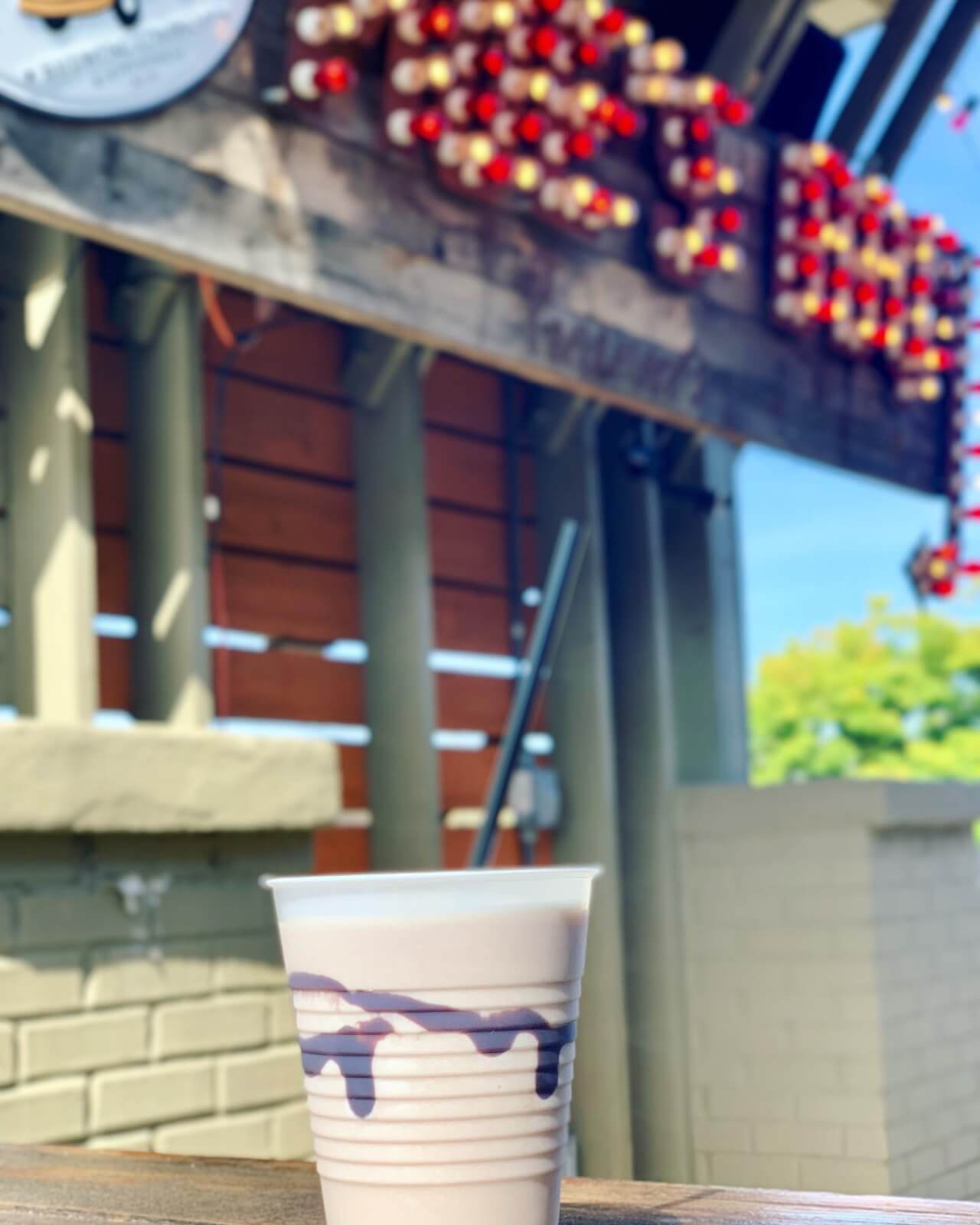 frozen milkshake with restaurant lights in background