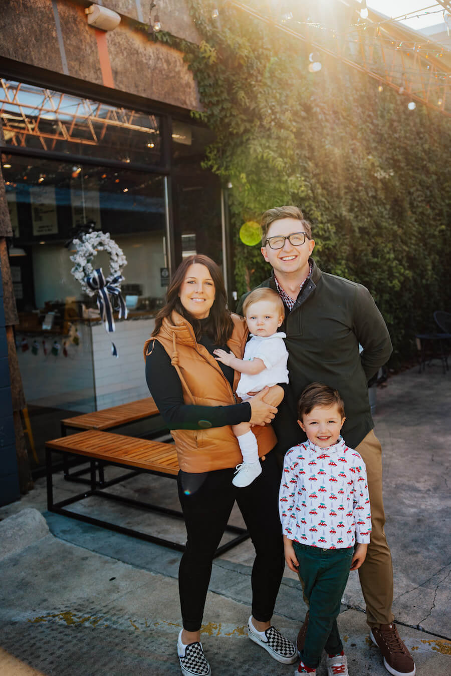 Geri-Martha posing with her husband and two sons.