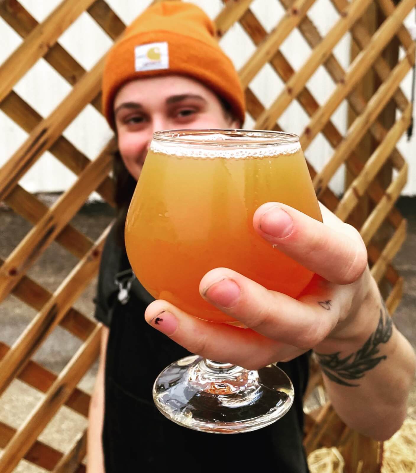 Woman holding a glass of beer.