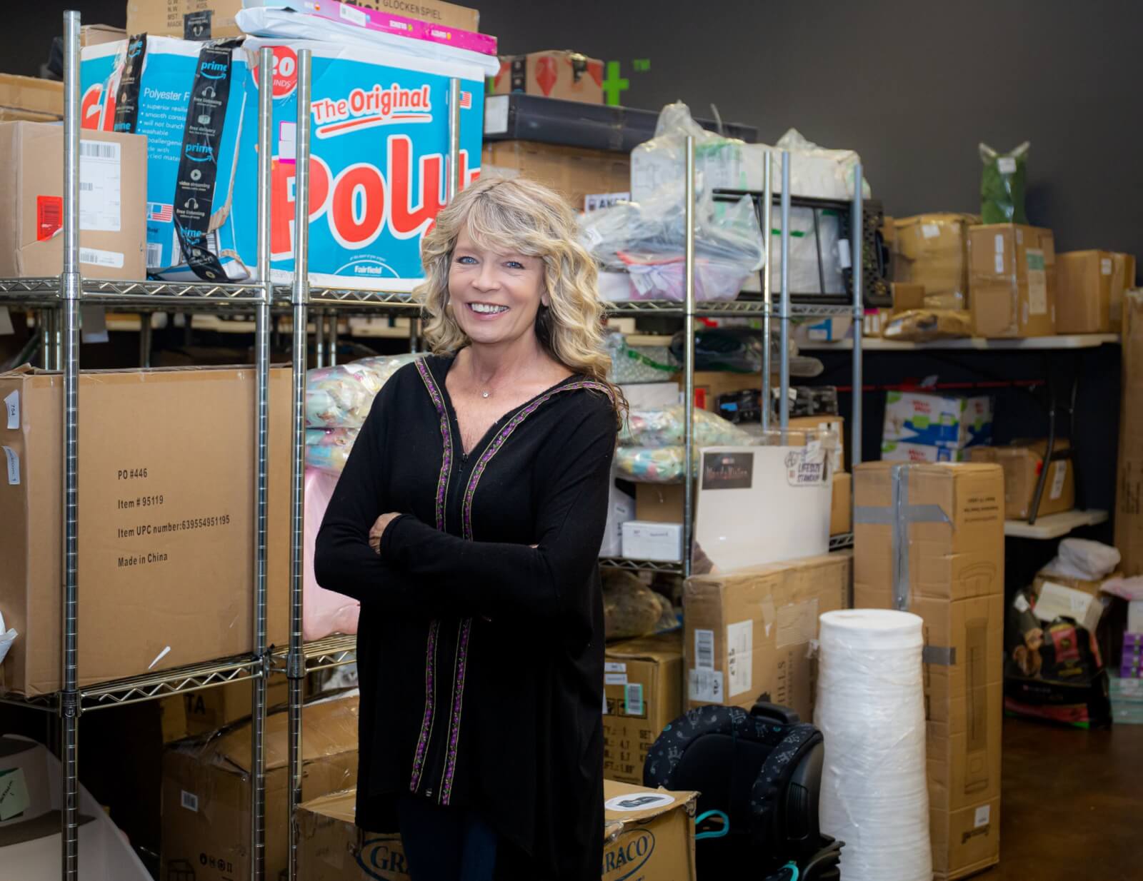 Mary Beth Lovell posing in an A-Stock warehouse.