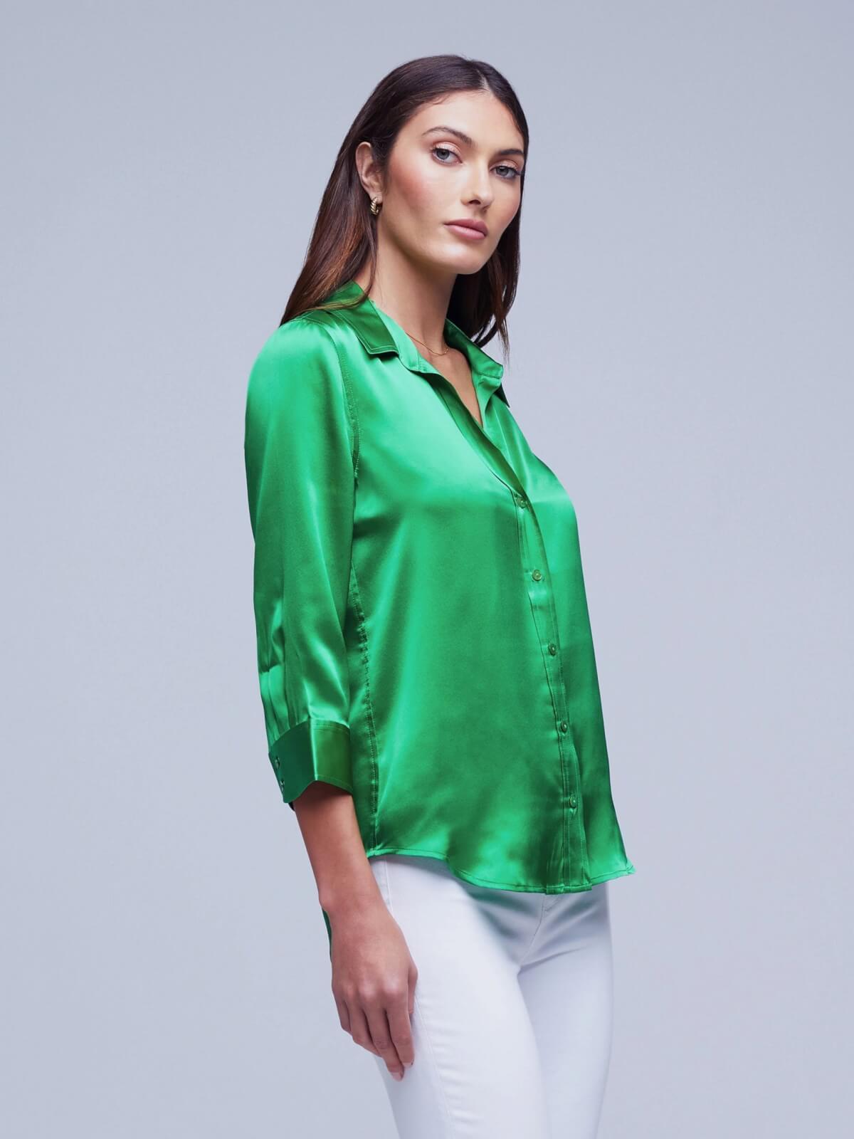 Model in white pants and green Dani blouse