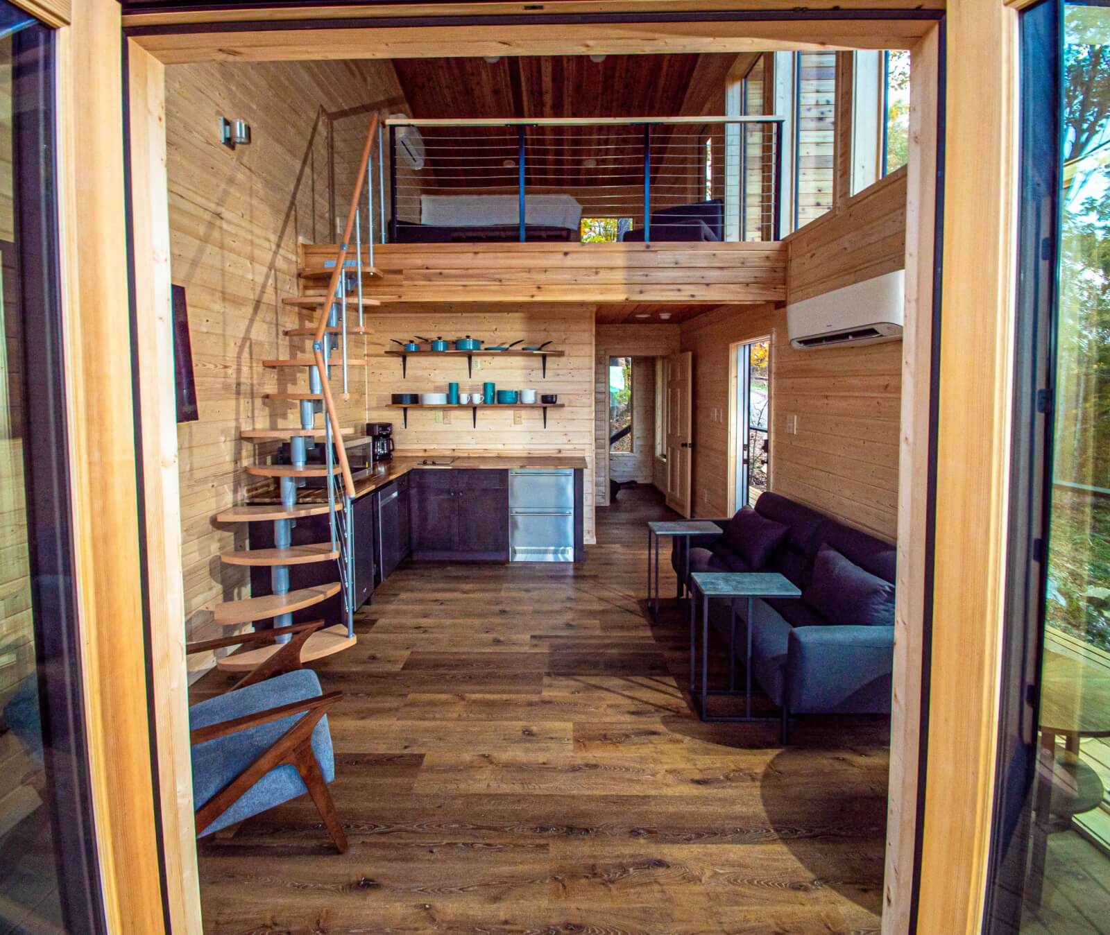 View of living room and loft areas from outdoor porch area.