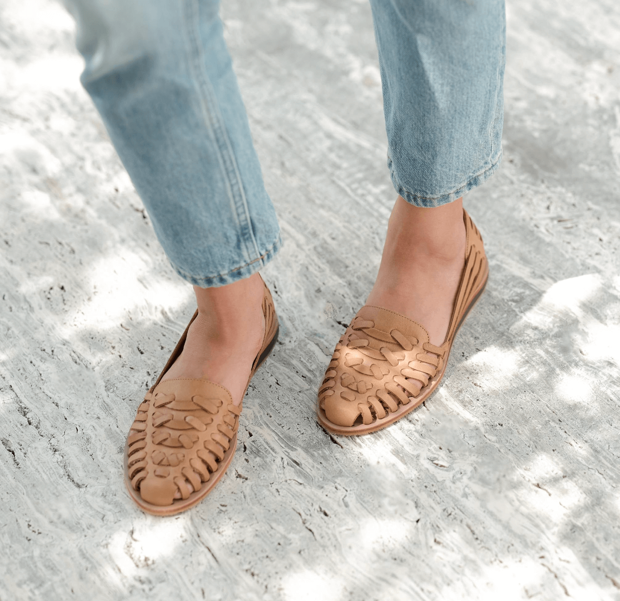 Nisolo woven flats on woman wearing jeans